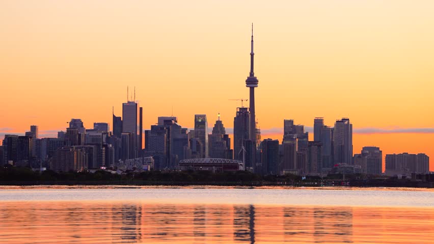 Toronto, Ontario, Canada downtown skyline on Lake Ontario at dawn.