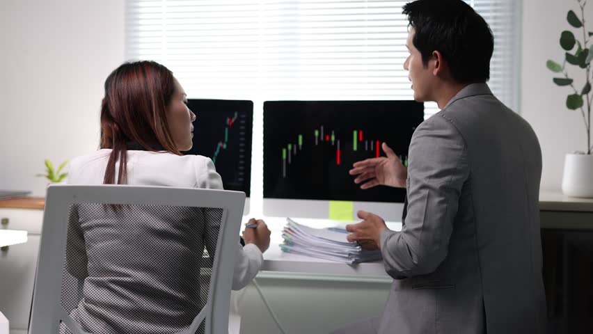 Business people discussing negative stock market results.