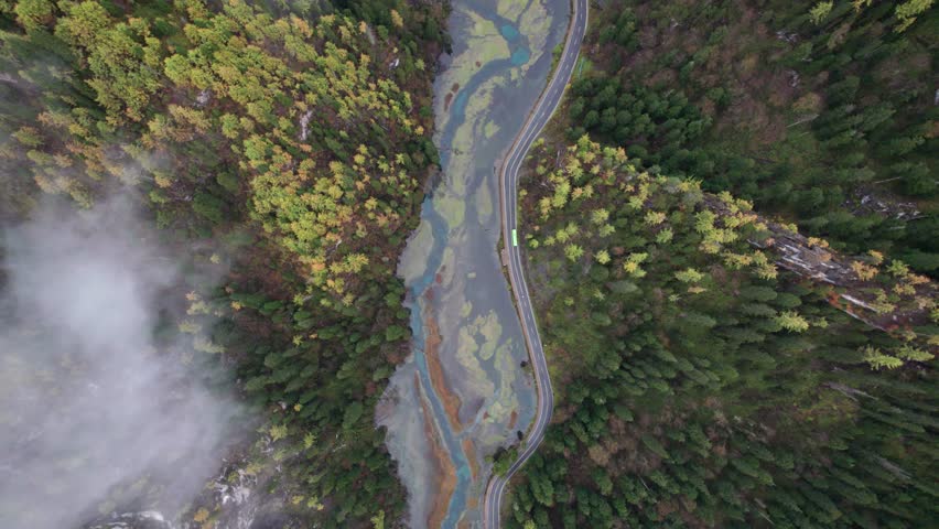 Drone view of Jiuzhaigou National Park in autumn in Sichuan Province China. It features cascading waterfalls, turquoise blue lakes, and stunning mountain valleys. 4K real time footage travel concept