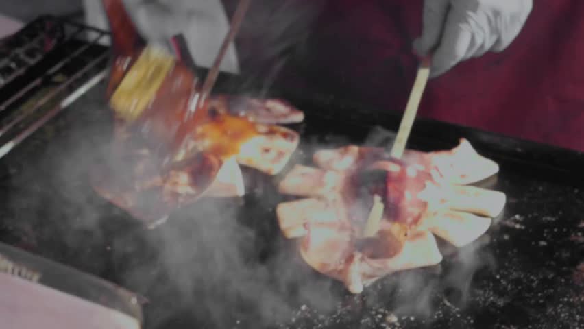 Close-up of chef grilling pizza on a barbecue grill outdoors