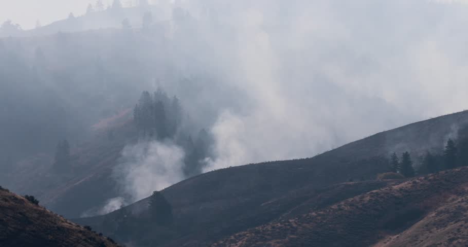 The sky is hazy and the mountains are covered in smoke. The scene is quite ominous and foreboding in the Boise Idaho foothills