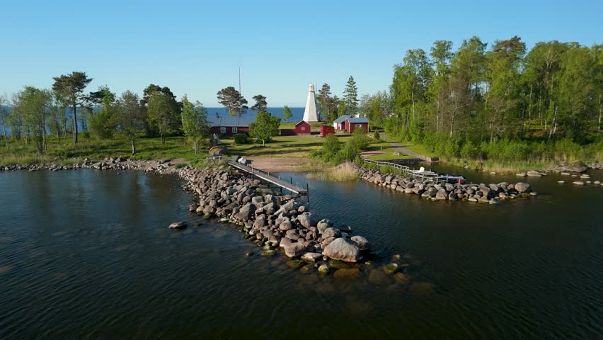 Drone flight over historic white wooden lighthouse Hjortens Udde at Lake Vanern shoreline in Mellerud