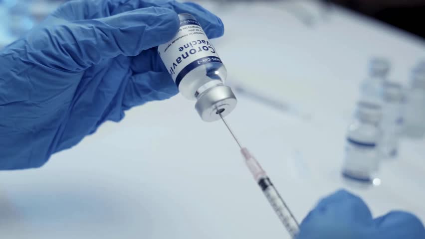 A medical professional Tilt up shot of male doctor with Syringe ready for injection concept anesthesiology Medicine and vaccination in slow motion