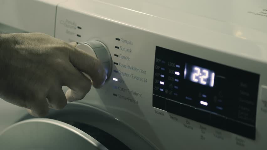 Adjusting Wash Settings on Washing Machine Close Up