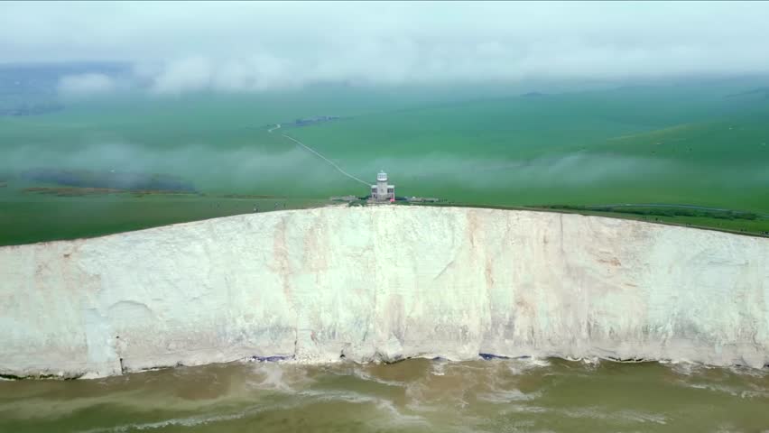 Panorama of the Seven Sisters white chalk cliffs during high tide, East Sussex, England.

