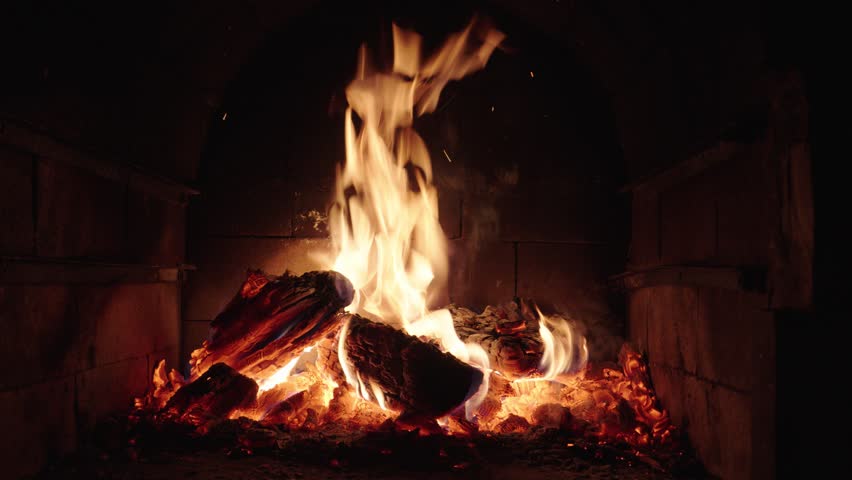 Crackling fire in a rustic fireplace showcasing warmth and comfort