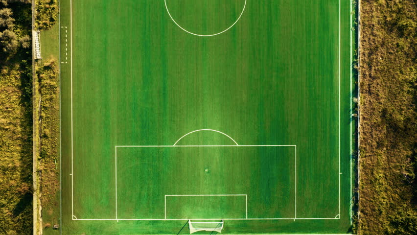 Soccer field with green grass seen overhead aerial
