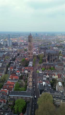Stunning aerial view of Utrecht featuring the historic Dom Tower and medieval city center. A perfect vertical capture of the highest church tower in the Netherlands for your travel inspiration.