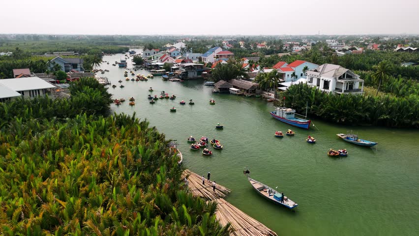 Tourists on basket boats on a river in hoi an, vietnam, surrounded by a coconut forest, Aerial view.