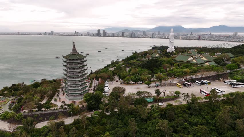 Aerial view of linh ung pagoda and the lady buddha statue with the da nang skyline in vietnam.