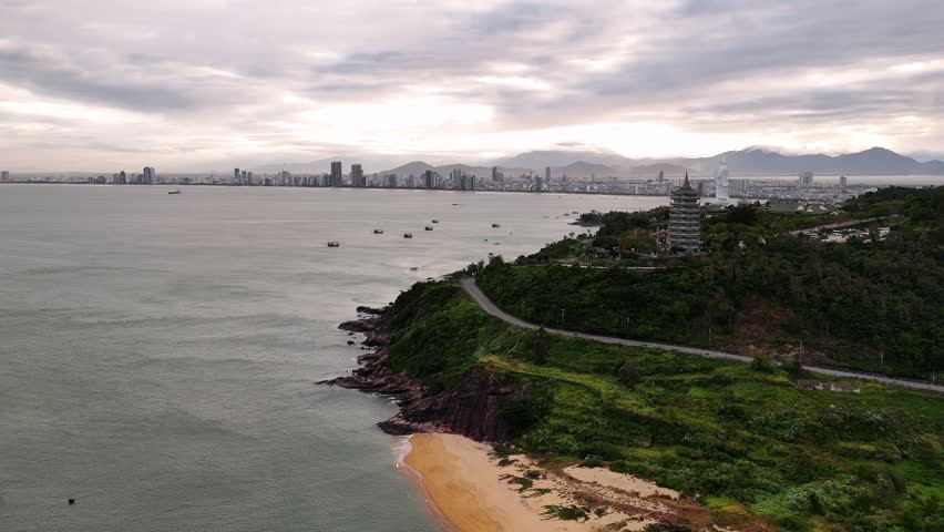 Aerial view of da nang city skyline, and linh ung pagoda in vietnam under a cloudy sky.
