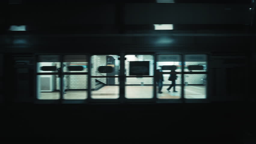 View from inside moving subway train as metro stops at underground station platform in Seoul South Korea