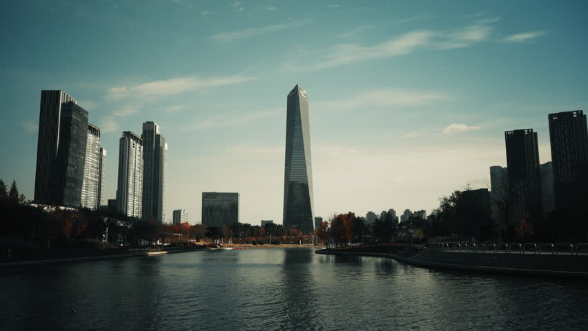 Static cinematic skyline view of Songdo International Business District with G Tower rising above Central Park lake in Incheon South Korea