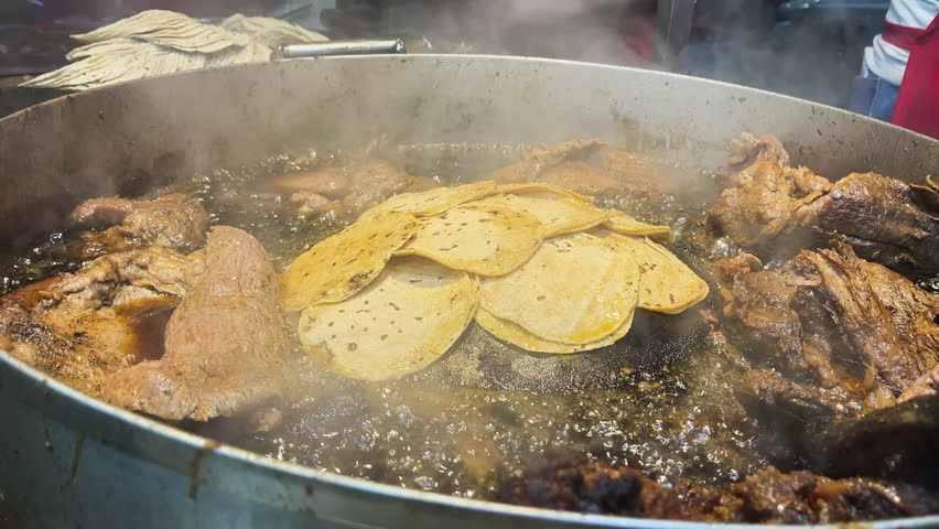 Close-up shot of traditional Mexican street tacos with suadero and longanisa meat being prepared on a griddle. Authentic culinary experience in CDMX