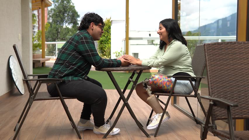 Loving couple talking on a romantic date, the woman has a prosthetic leg