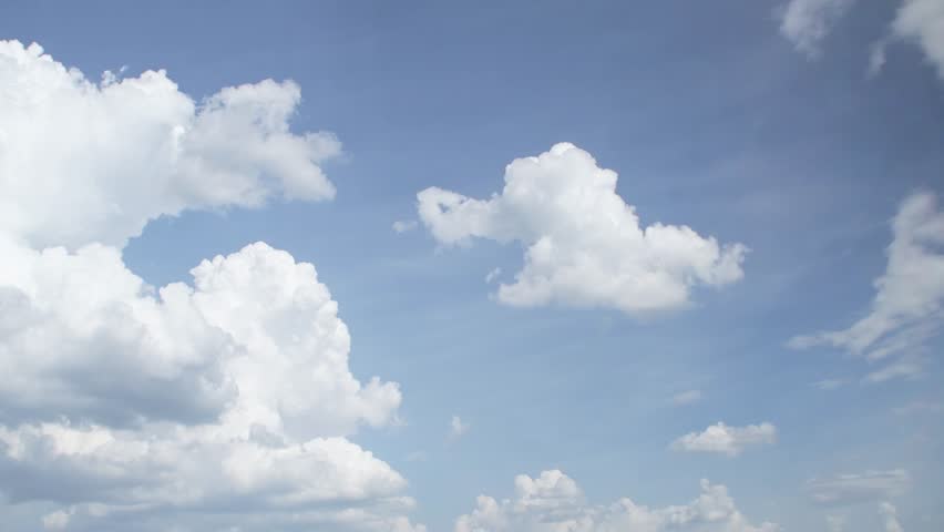 Beautiful fluffy clouds drifting across a bright blue sky during a sunny afternoon in a peaceful outdoor setting. Calm and romantic background with clouds on the weather theme.