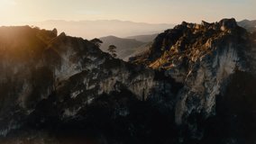 Cinematic 4K aerial drone shot flying Over Mountain Ridge discovering green valley below, revealing layered peaks and serene wilderness landscape. - Powered by Shutterstock - Get 15% off with code: PIKWIZARD15