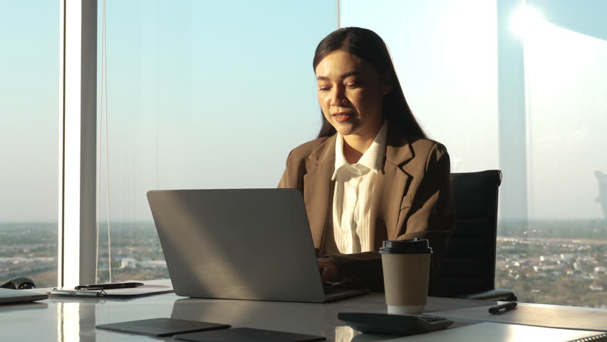 businesswoman working on laptop computer in business high-rise office 