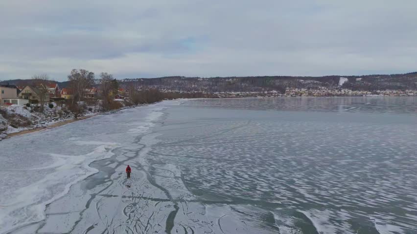 Winter Scene with Lone Person on Frozen Lake.