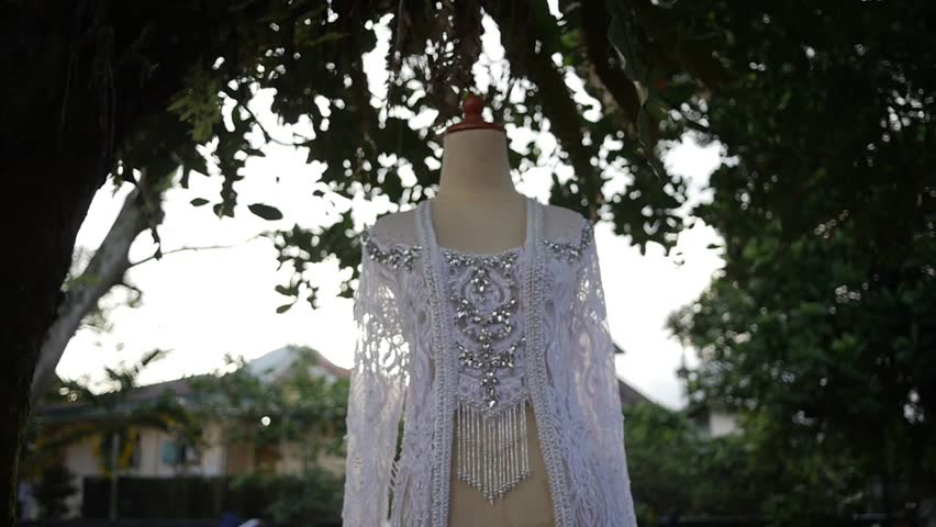 Traditional Southeast Asian white wedding dresses complete with decorations and ornaments, and are worn by the bride and groom. Real time outdoor natural lighting RAW no edit footage video file