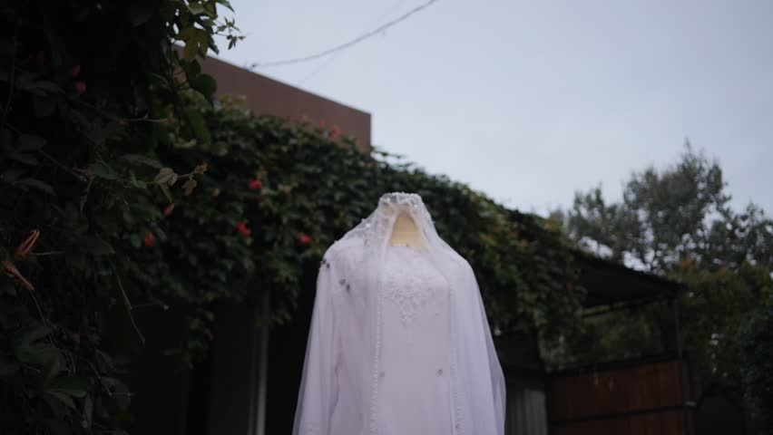 Traditional Southeast Asian white wedding dresses complete with decorations and ornaments, and are worn by the bride and groom. Real time outdoor natural lighting RAW no edit footage video file