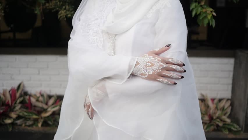 Traditional Southeast Asian white wedding dresses complete with decorations and ornaments, and are worn by the bride and groom. Real time outdoor natural lighting RAW no edit footage video file