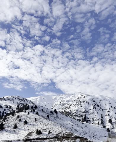 Snow-Capped Mountains Under Cloudy Sky.