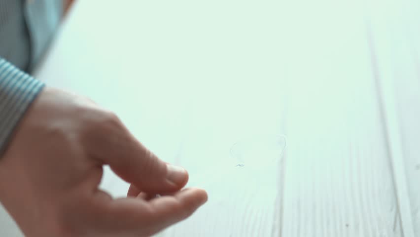 Man pouring liquid cough syrup into a spoon, medication dosage and healthcare concept.