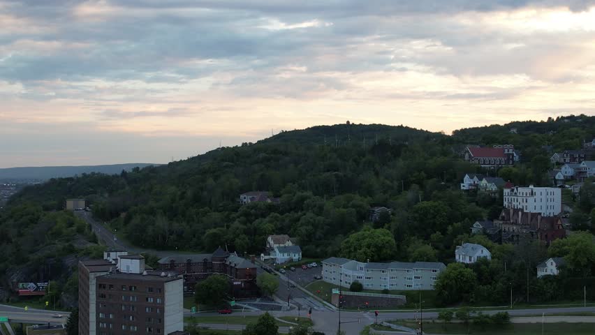 Aerial of downtown Duluth Minnesota at dusk. Approach shot of residential area on hillside.