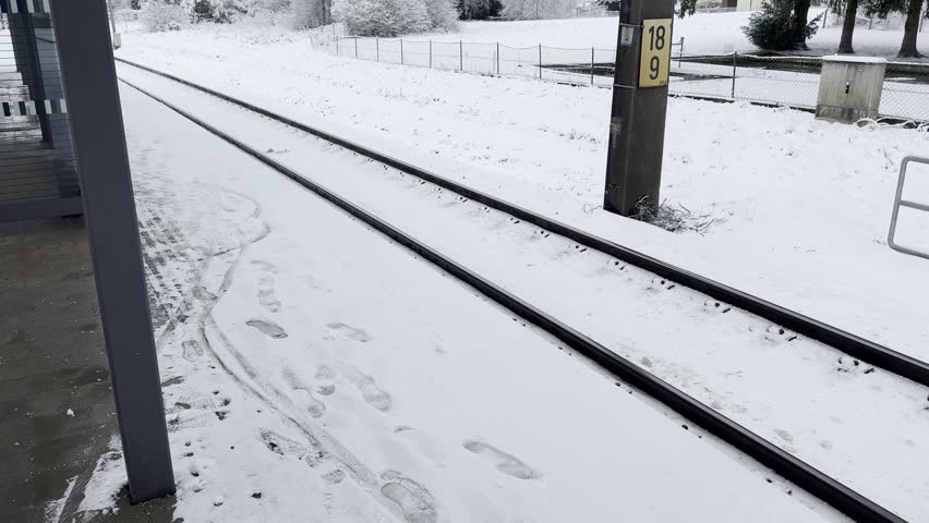 footprints on snow covered railway station platform