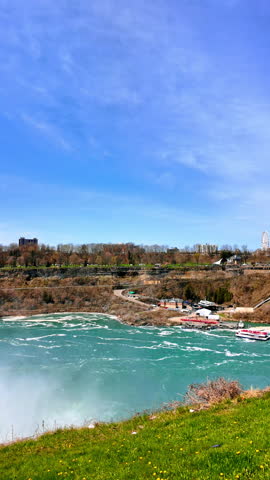 City landscape over Niagara Falls. Skylon Tower in the scenery. View on the majestic landmark from American side. Vertical video.