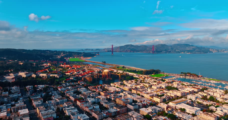 Approaching the Palace of Fine Arts in the cityscape of San Francisco, California, USA. Beautiful San Francisco Bay with the Golden Gate Bridge at backdrop. Aerial view.