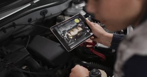 Female tech holding tablet near car engine rotating tablet checking diagram as overlays scanning. Technician, diagnostics, garage, interface, device, powertrain, wiring - Powered by Shutterstock - Get 15% off with code: PIKWIZARD15