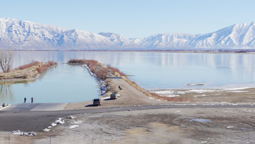 View from moving vehicle of Lincoln beach marina at Utah Lake.