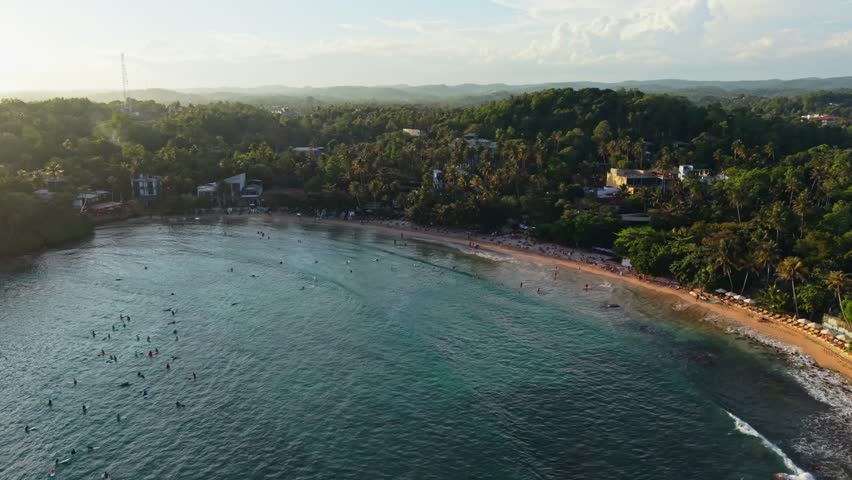 Sunset over the jungle of Hiriketiya beach in Sri Lanka