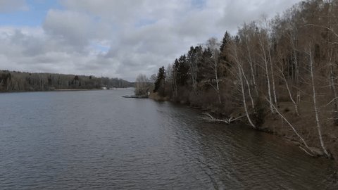 Drone Gliding Low above River Coast