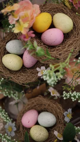 Vertical screen unsold decorative Easter eggs arranged in small straw nests surrounded by spring flowers waiting for disposal after the holiday season with soft pastel colors and festive motifs
