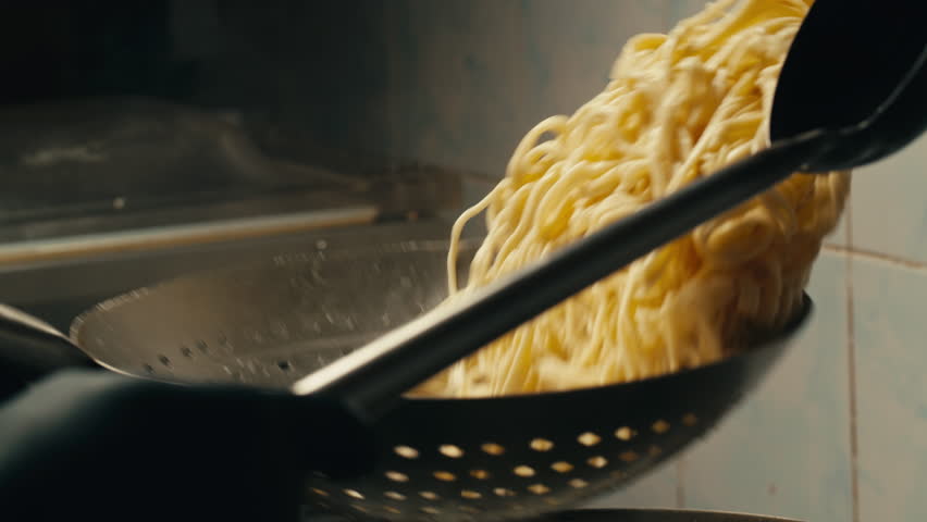 Asian Wok noodles cooking, Chef cooking handmade pasta wok frying pan close-up. Chinese traditional beef and chicken vegetables on fire pan, japanese korean pasta. Restaurant Food concept. Sea food.