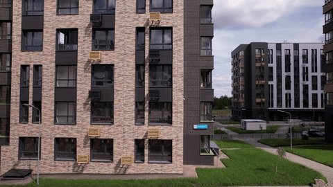 Aerial Rise along Apartment Building Facade