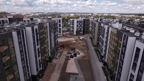 Drone Advancing Pitching Down over Construction