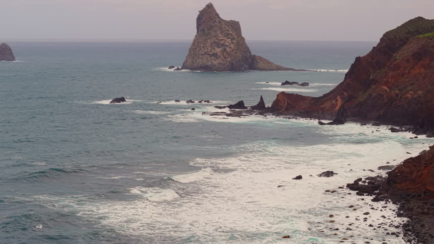 Beautiful view of the Roques de Anaga on Benijo beach in Tenerife. The wild volcanic coastline of Tenerife meeting the Atlantic Ocean