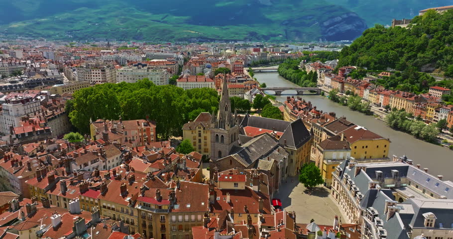 Aerial view of Grenoble. Panoramic view featuring the Isere river, urban landscape, mountains in the French Alps at summer