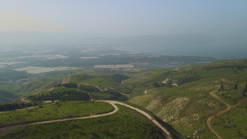 Sea of Galilee landscape in Israel is framed by the fast-moving view over Mevo Hama forest.