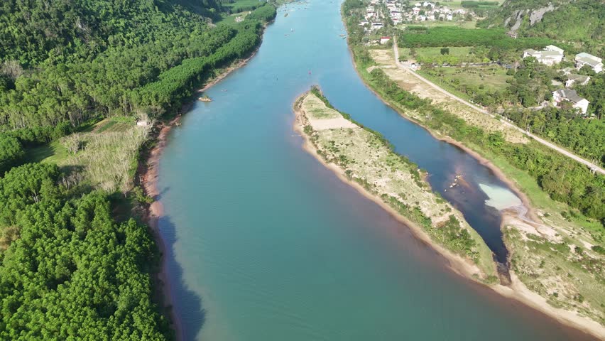 Phong Nha – Ke Bang National Park, Bo Trach, Quang Binh, Central Vietnam – 4K aerial footage of UNESCO Heritage site with Son River, limestone karst mountains, rice fields, tropical forest and cave entrance