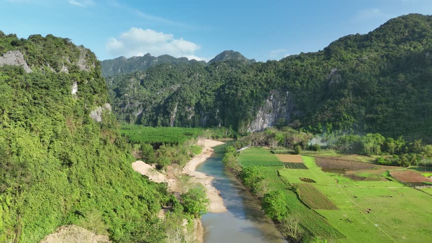 Phong Nha – Ke Bang National Park, Bo Trach, Quang Binh, Central Vietnam – 4K aerial footage of UNESCO Heritage site with Son River, limestone karst mountains, rice fields, tropical forest and cave entrance