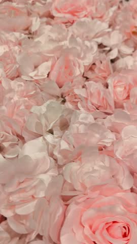 A delicate background of many pink artificial roses