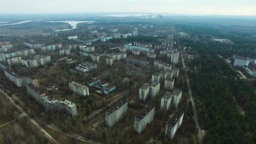 Aerial view of Pripyat, an abandoned city near Chernobyl Nuclear Power Plant. Decaying residential blocks, overgrown streets, New Safe Confinement.