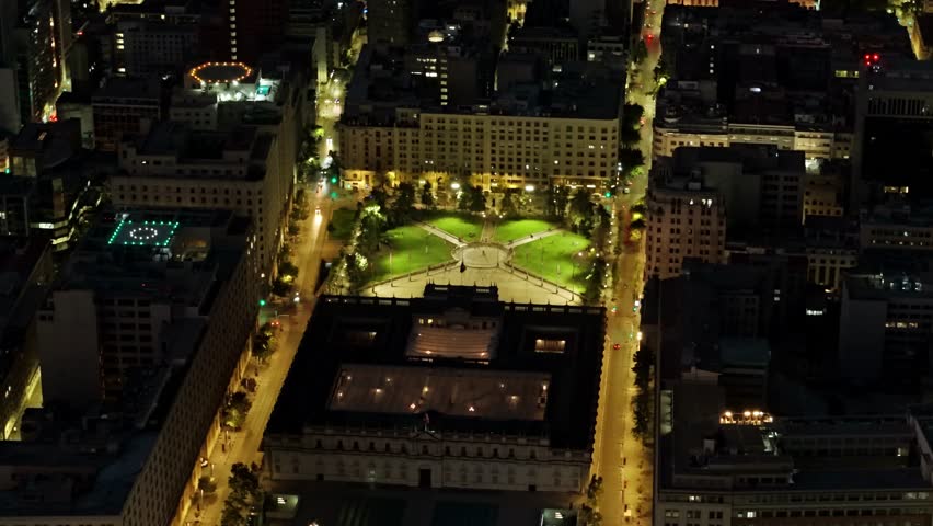 Aerial telephoto shot of La Moneda and Constitution Square in the civic district of Santiago, Chile, at night
