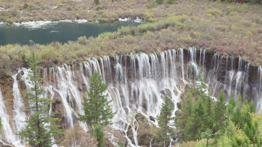 High angle view of Nuorilang Falls or Nuorilang waterfall. Beautiful landscape of Jiuzhaigou National Park in autumn in Sichuan Province China. 4K slow motion footage travel concept.