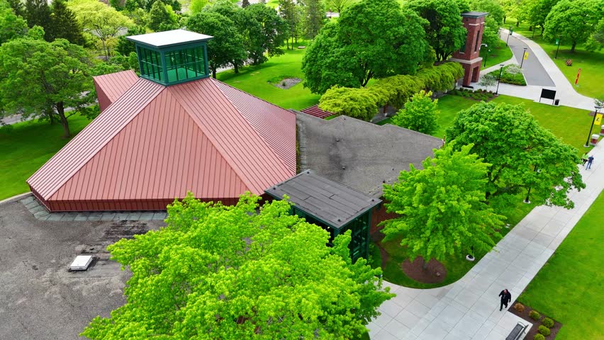 Aerially carrying across a college campus and capturing the astonishing educational institution that students get the opportunity to interact with. Syracuse, NY, USA - May 30, 2025.